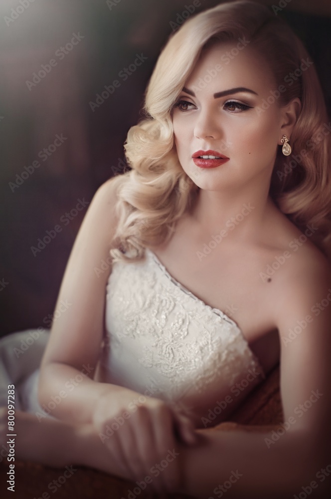 Beautiful bride blonde with stylish make-up in white dress