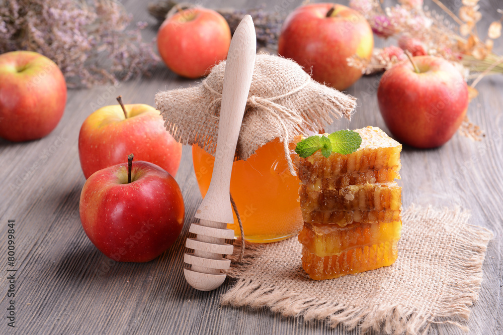Delicious honey with apple on table close-up Delicious honey with apple on table close-up
