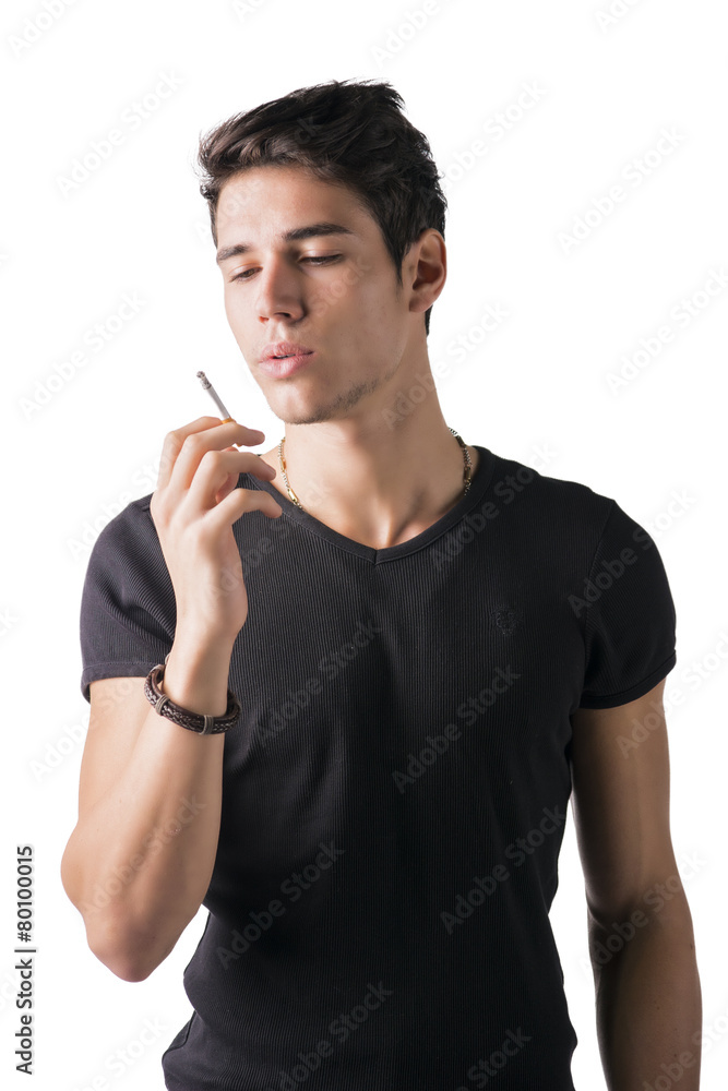 Handsome young man looking at his cigarette Handsome young man looking at his cigarette