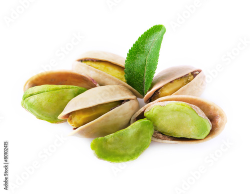 Pistachio with leaves isolated on white.