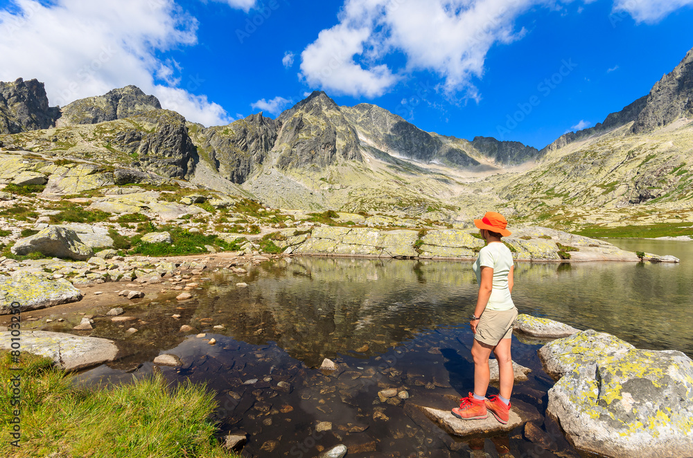 Woman tourist standing on rock in Tatra Mountains, Slovakia