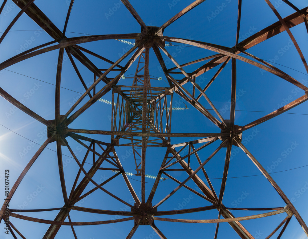 High-voltage  iron rusty  mast. Tangent tower, Blue sky.