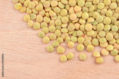 Close up of green lentil on wooden background