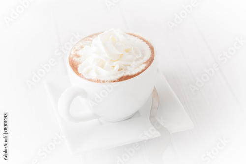 a cup of coffee with wheap cream, isolated, vignetted