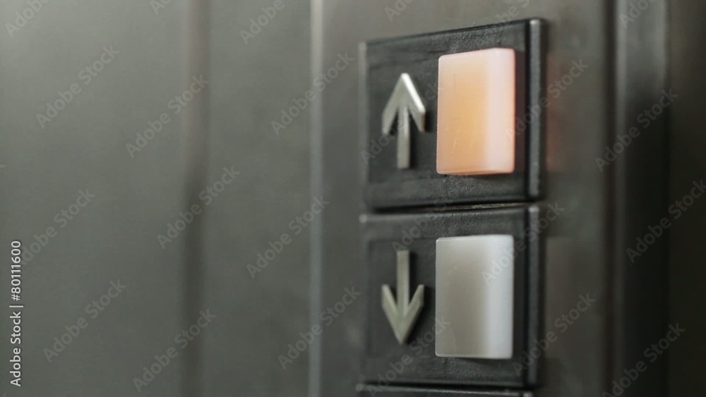 Manicured finger presses the button for an elevator. After a pause, presses button repeatedly. Dolly shot with macro lens and shallow focus. Manicured finger presses the button for an elevator. After a pause, presses button repeatedly. Dolly shot with macro lens and shallow focus.