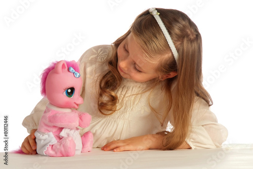 girl playing with her toy pony