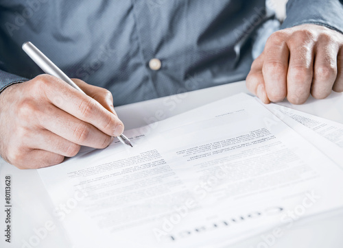 Businessman signing a legal document