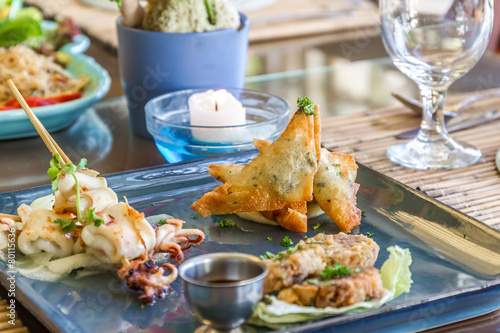 seafood snacks, calamaris, squid rings served in outdoor restaur photo