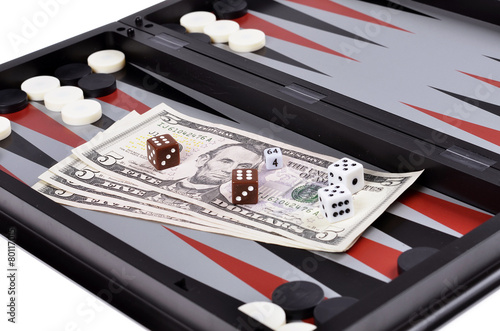 Dollar bills with dice on the   backgammon