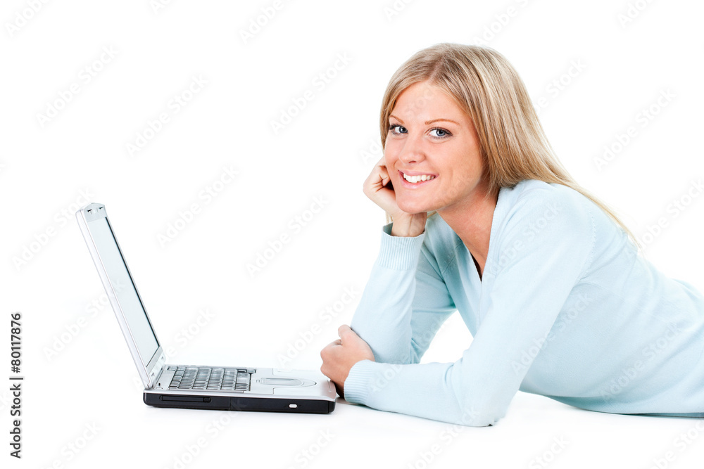 Blonde girl working on laptop, white background Blonde girl working on laptop, white background