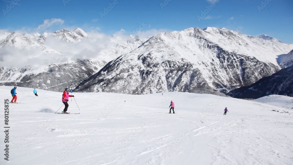 Skier turns on hillside and goes down to slope bottom Skier turns on hillside and goes down to slope bottom