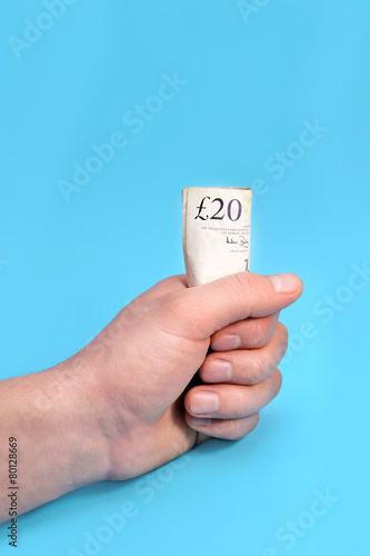 Men holding a 20 pounds in palm on blue background