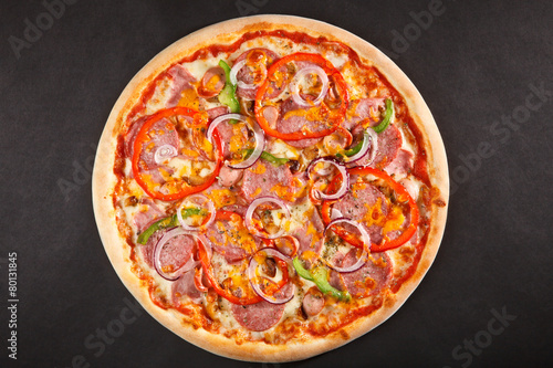 Tasty Italian pizza with pepper onion salami