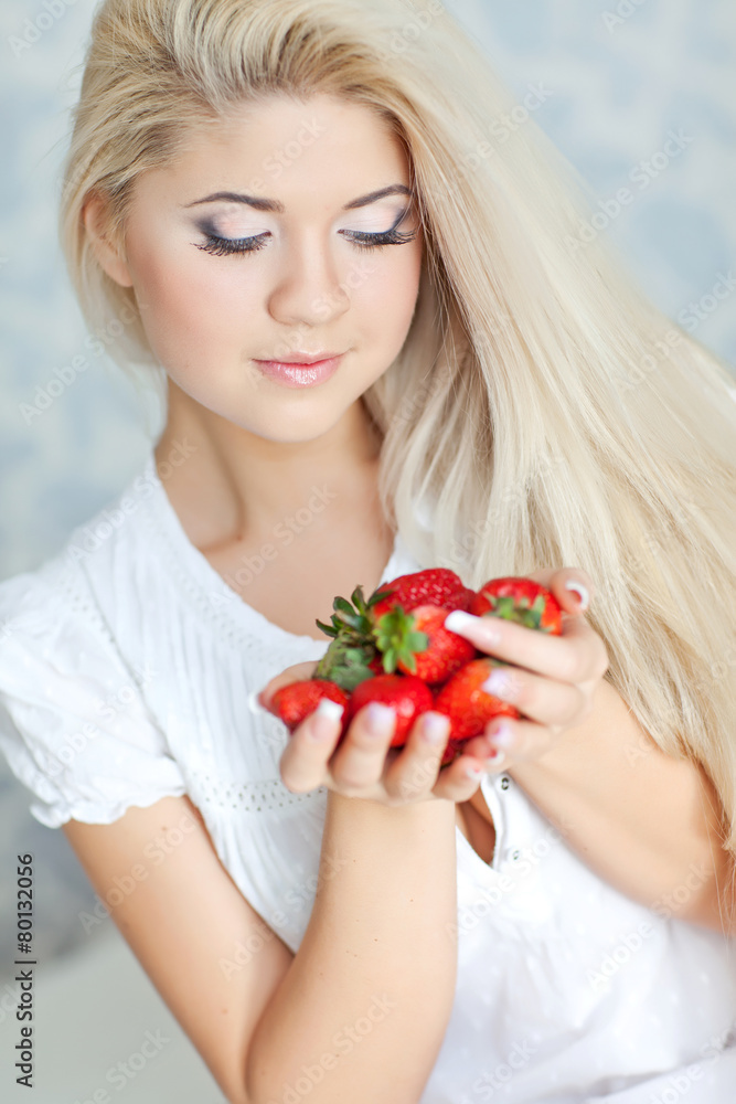 Beautiful blonde are eating the strawberry in the morning Beautiful blonde are eating the strawberry in the morning