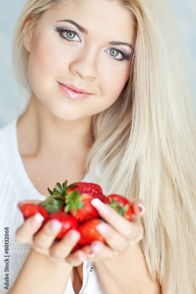 Beautiful blonde are eating the strawberry in the morning Beautiful blonde are eating the strawberry in the morning