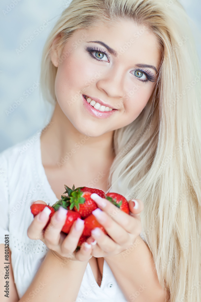 Beautiful blonde are eating the strawberry in the morning Beautiful blonde are eating the strawberry in the morning