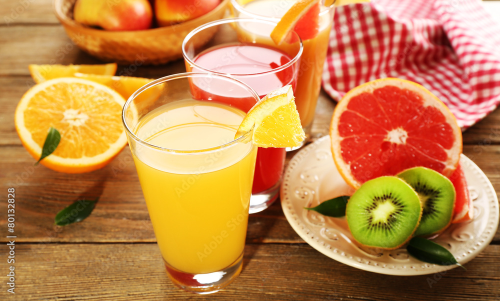 Fresh juices with fruits on wooden table Fresh juices with fruits on wooden table