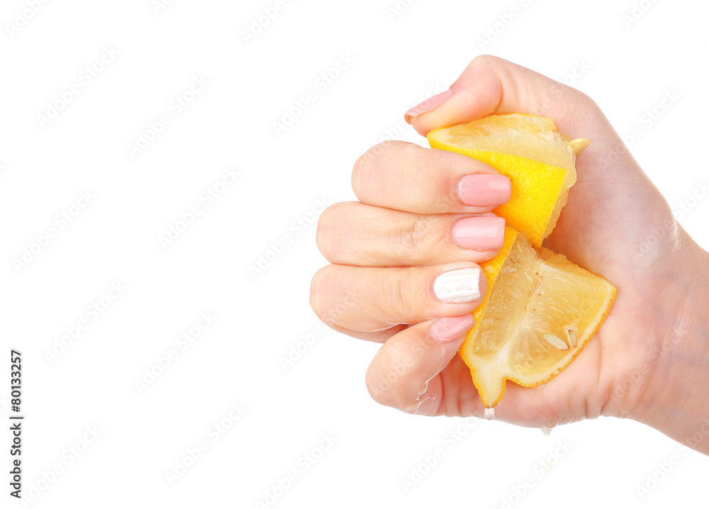 Female hand squeezing lemon isolated on white Female hand squeezing lemon isolated on white