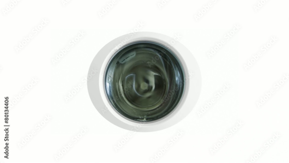 Clothes seen through door window on washing machine. Camera zooms through to a composited sequence with soap suds, clothes and bubbles containing washing machine images. Clothes seen through door window on washing machine. Camera zooms through to a composited sequence with soap suds, clothes and bubbles containing washing machine images.