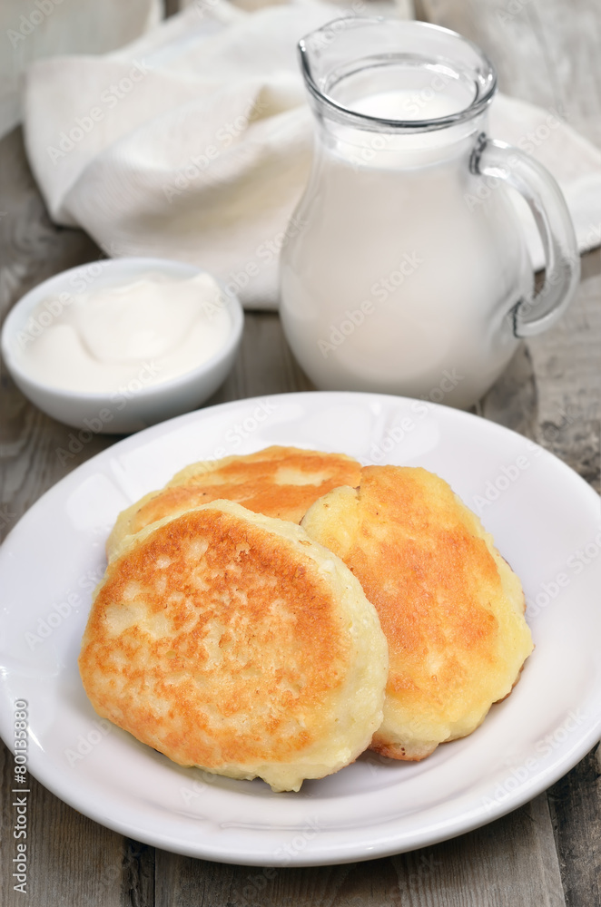 Fritters, sour cream and milk jug Fritters, sour cream and milk jug