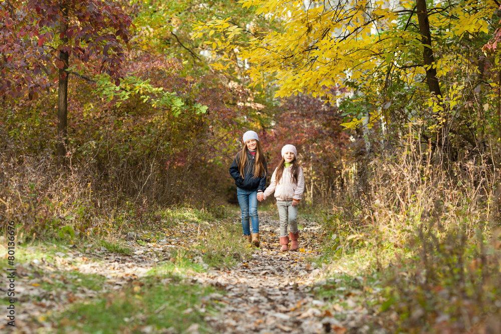 two girls walking in the woods two girls walking in the woods