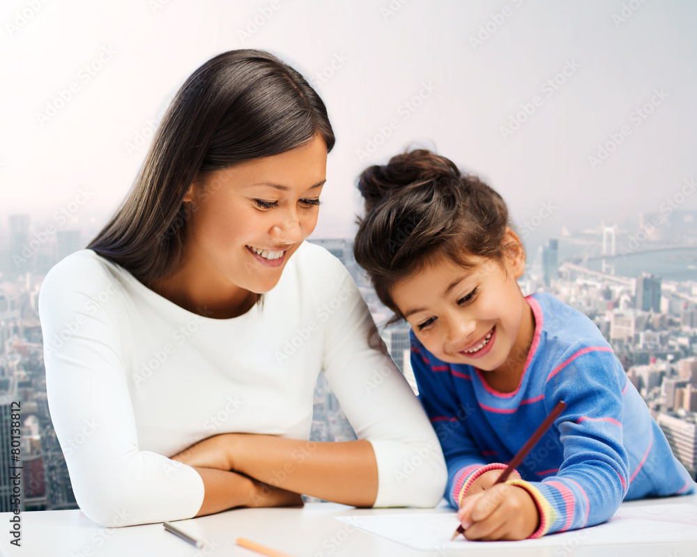 happy mother and daughter drawing with pencils happy mother and daughter drawing with pencils