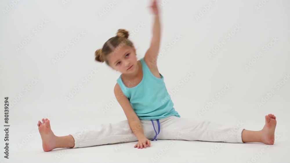 Little girl makes gymnastic exercise sitting on splits Little girl makes gymnastic exercise sitting on splits