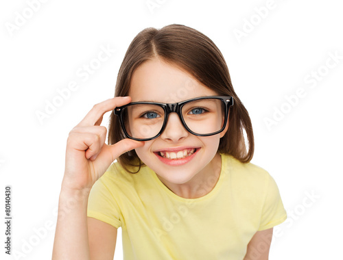 smiling cute little girl in black eyeglasses
