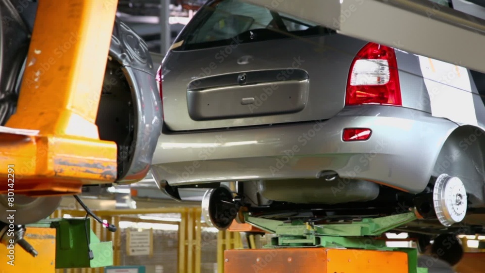 Conveyor transporter transfers unfinished car, closeup view