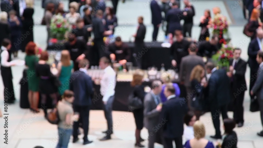 Many people walk by hall and talk near bar, (unfocused) Many people walk by hall and talk near bar, (unfocused)