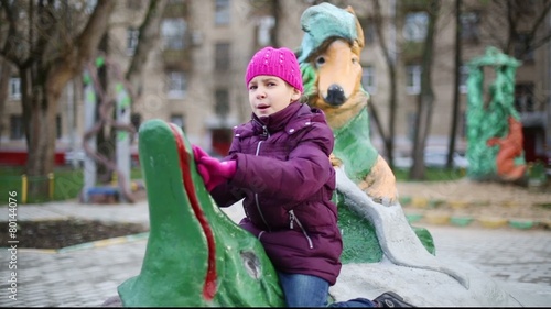 Anya plays in playground with sculptures Krylovs fables photo