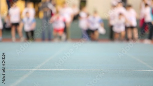 Finish line on track and running boys. Focus on finish line