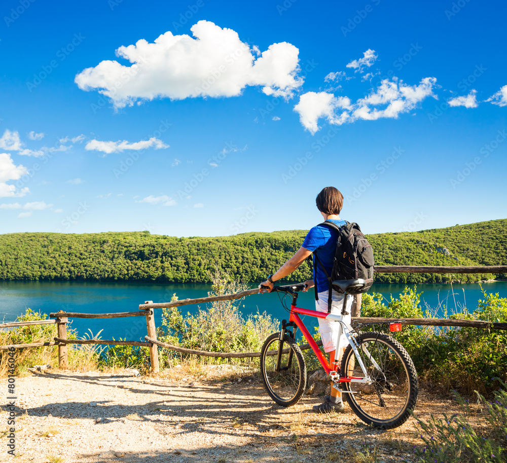 Man with a Bike on Beautiful Nature Background