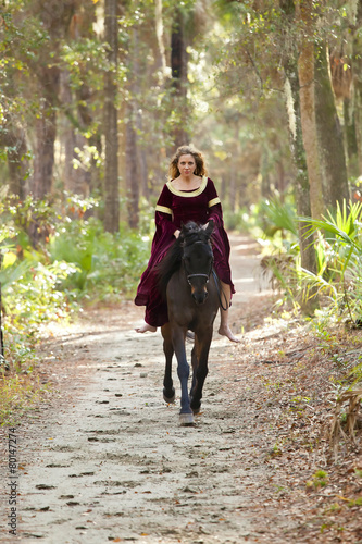 woman in medieval dress riding horseback