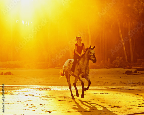 woman riding bareback at sunset