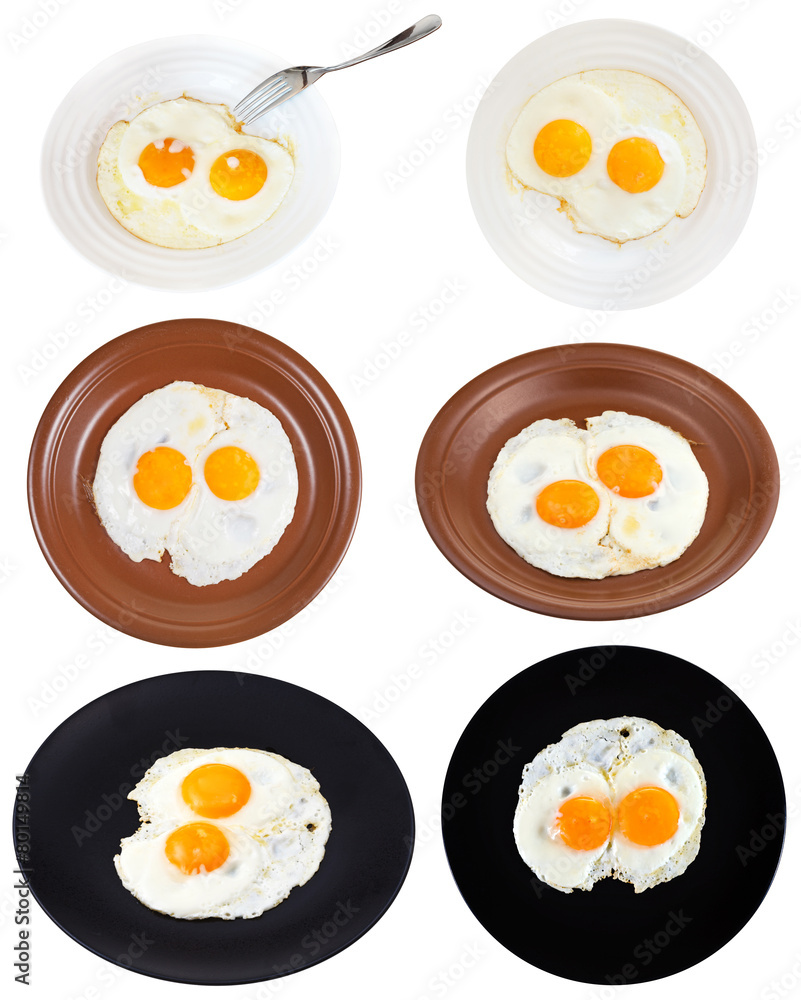 set from two fried eggs on plates isolated set from two fried eggs on plates isolated