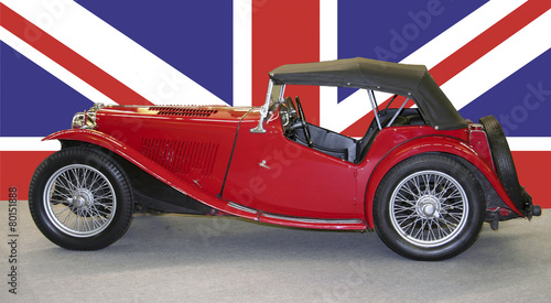 old red britsh car with british flag