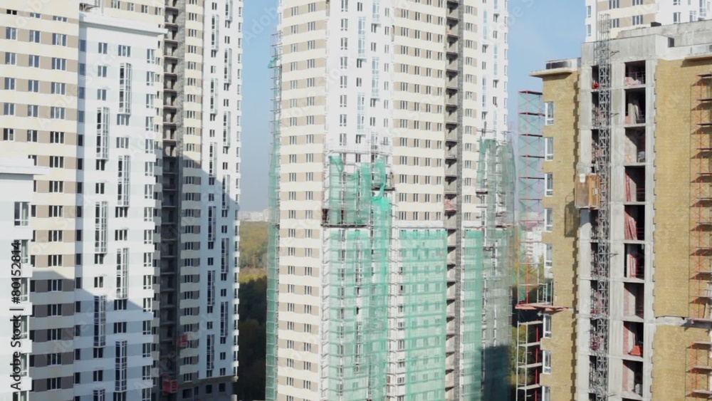 Elevator moves at wall of house at building site Elevator moves at wall of house at building site