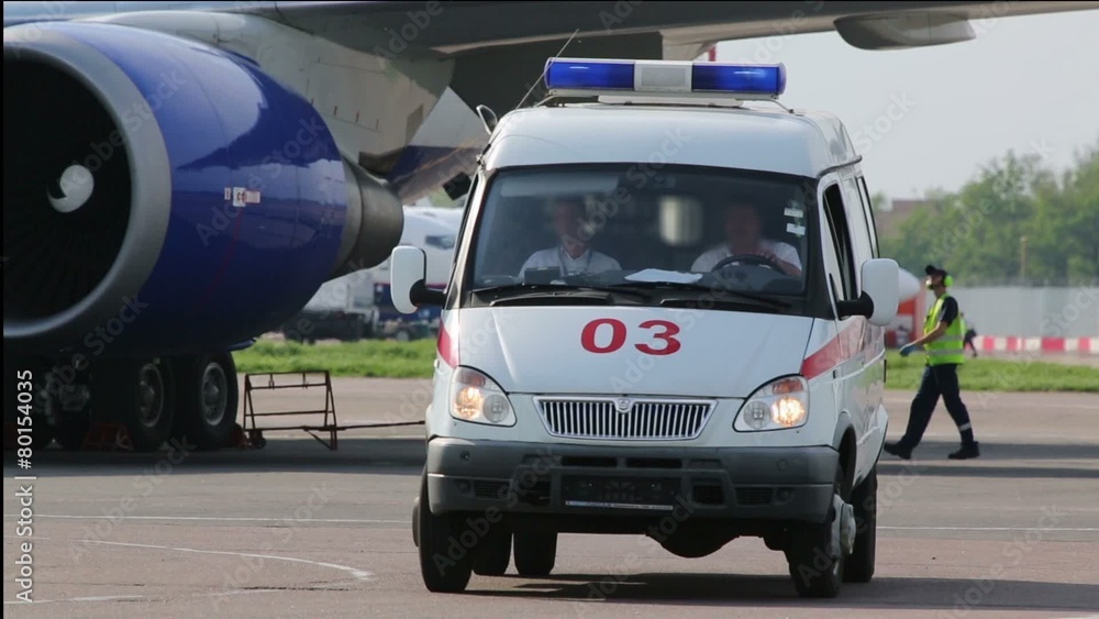 ambulance leaves from under the wing of an airplane ambulance leaves from under the wing of an airplane