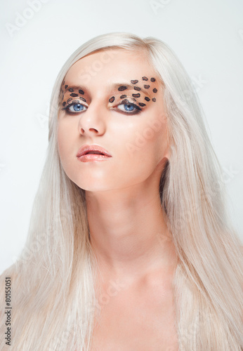 Portrait of a young beautiful woman with creative makeup
