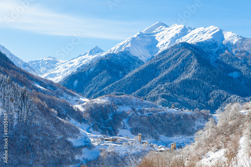 Mountain village on the snowy slope in Caucasus