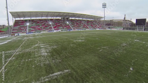 Grass surface with snow on field of football stadium photo