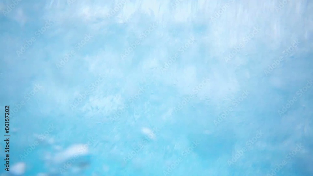 Man rides by colorful aqua slide in water park with glass roof Man rides by colorful aqua slide in water park with glass roof