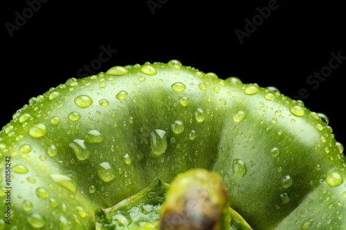 Macro cut shot of green bell pepper background with water drops