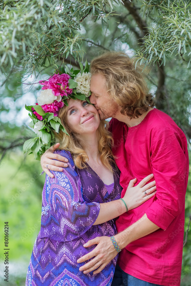 Happy pregnant couple hugging in nature Happy pregnant couple hugging in nature