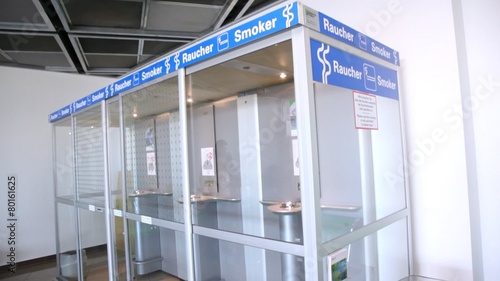 Empty smoking room with transparent glass walls in airport. photo