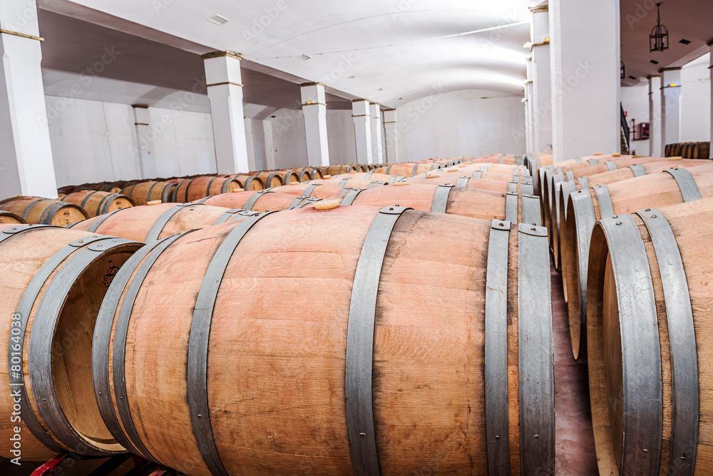 American oak barrels with red wine. Traditional wine cellar American oak barrels with red wine. Traditional wine cellar