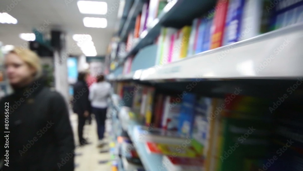 Blur view of library with long bookcase and people Blur view of library with long bookcase and people