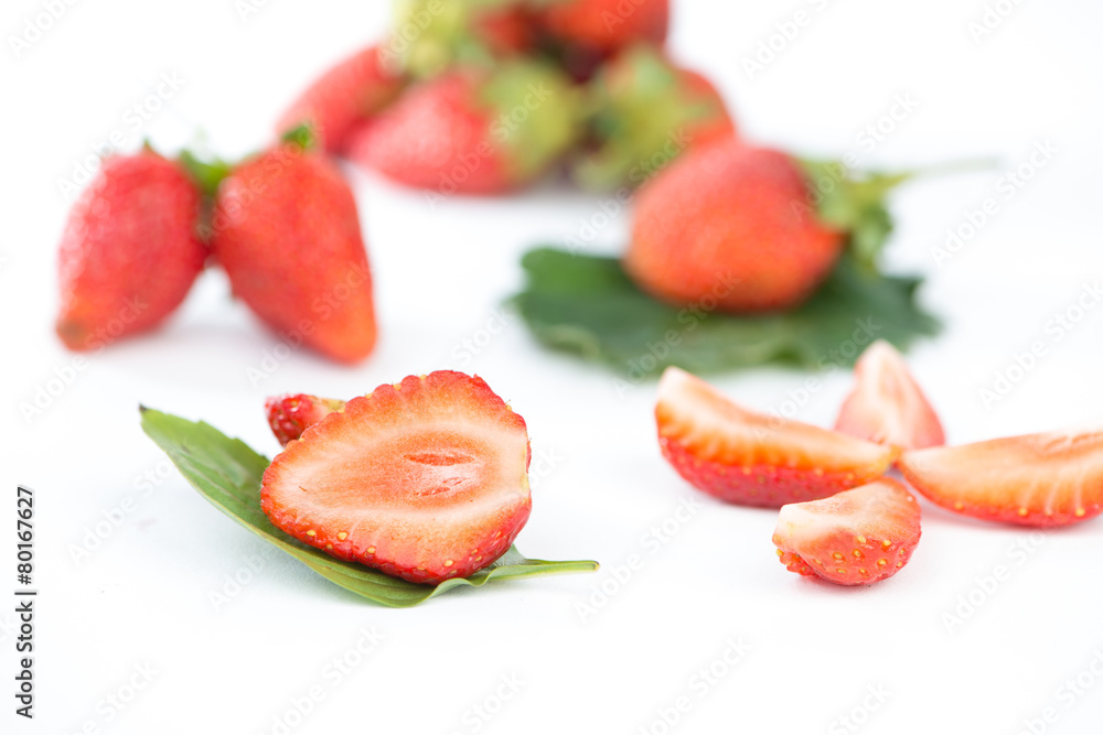 Closed up half of strawberry on green leaf Closed up half of strawberry on green leaf