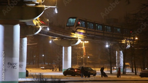 Train on metro bridge in a snowy evening photo